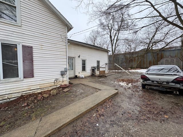 view of side of property featuring fence