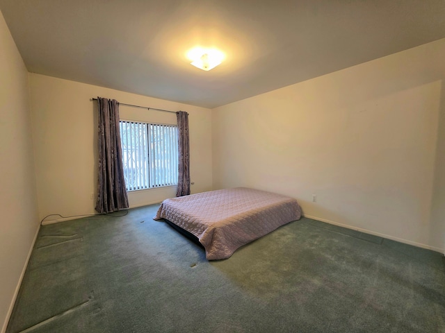 bedroom featuring carpet and baseboards