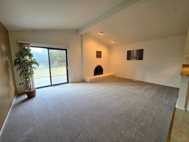 unfurnished living room featuring lofted ceiling with beams, a fireplace, baseboards, and carpet flooring