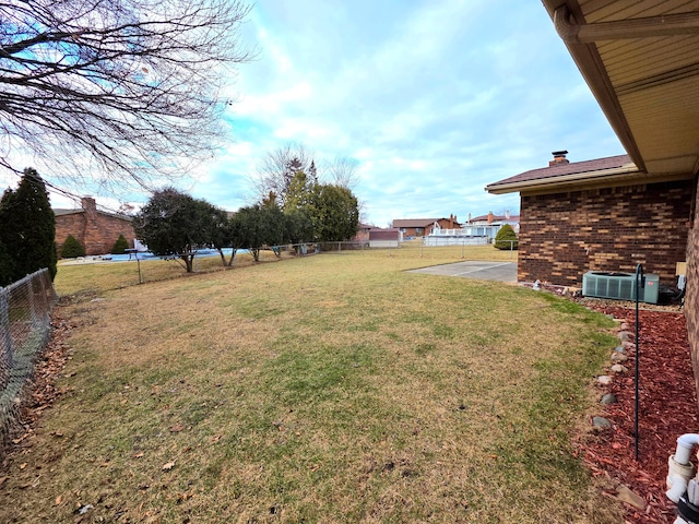 view of yard featuring fence and cooling unit