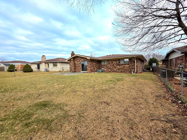 rear view of house with a patio area, a fenced backyard, a yard, and central air condition unit