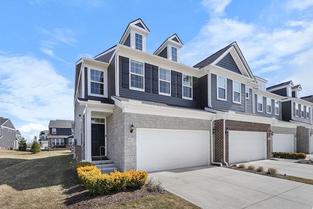 multi unit property featuring concrete driveway, an attached garage, brick siding, and stone siding