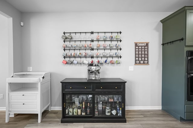 bar featuring baseboards and wood finished floors