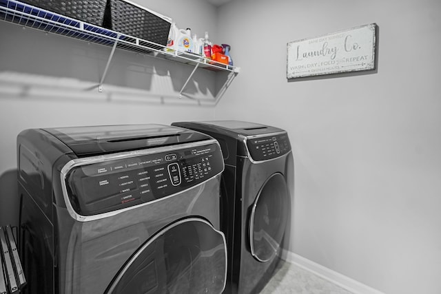 laundry room with laundry area, independent washer and dryer, and baseboards