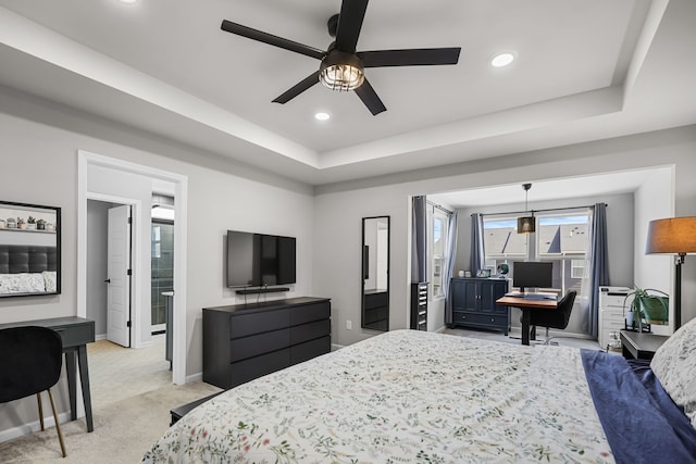 bedroom with recessed lighting, a tray ceiling, baseboards, and light colored carpet