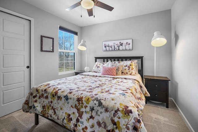 bedroom featuring baseboards, a ceiling fan, and carpet flooring