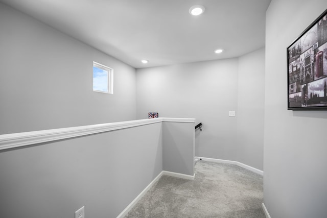 hall with recessed lighting, an upstairs landing, baseboards, and carpet floors