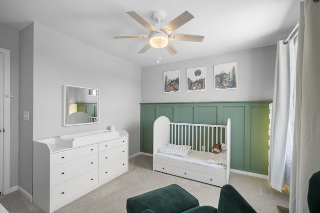 bedroom with baseboards, light colored carpet, and a ceiling fan