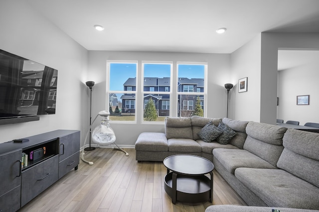 living room featuring baseboards and light wood-style floors