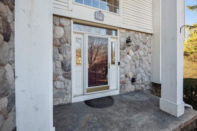 view of exterior entry featuring stone siding