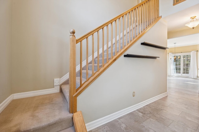 stairway with baseboards and wood finished floors