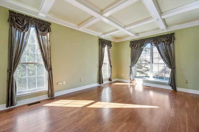 spare room with visible vents, baseboards, coffered ceiling, and hardwood / wood-style flooring