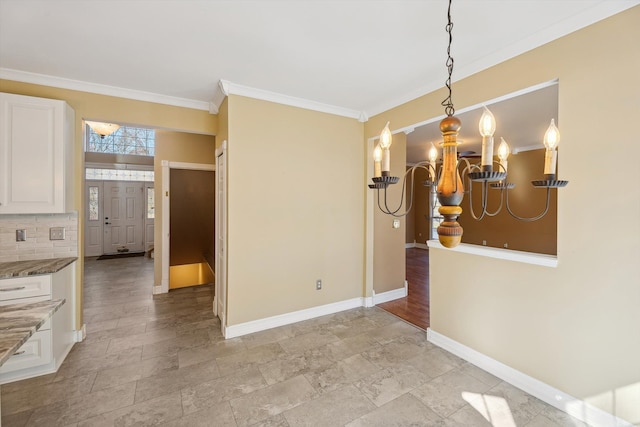 dining space featuring crown molding and baseboards