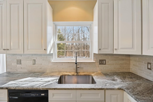 kitchen featuring a sink, light stone counters, white cabinets, decorative backsplash, and dishwasher