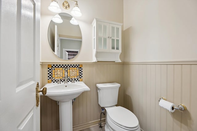 bathroom with toilet and wainscoting