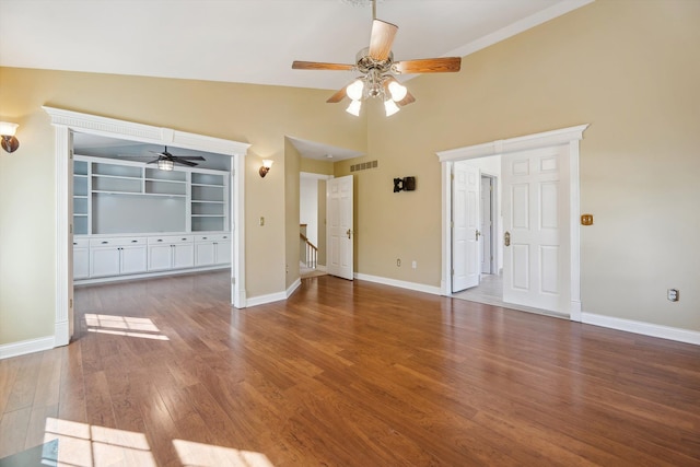 unfurnished living room featuring visible vents, a ceiling fan, wood finished floors, baseboards, and lofted ceiling