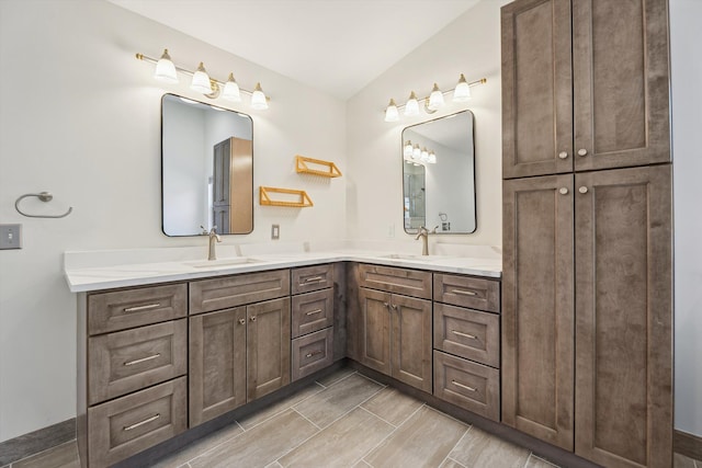 full bath with double vanity, wood finish floors, and a sink