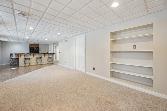 unfurnished living room featuring baseboards, built in features, a dry bar, carpet floors, and recessed lighting