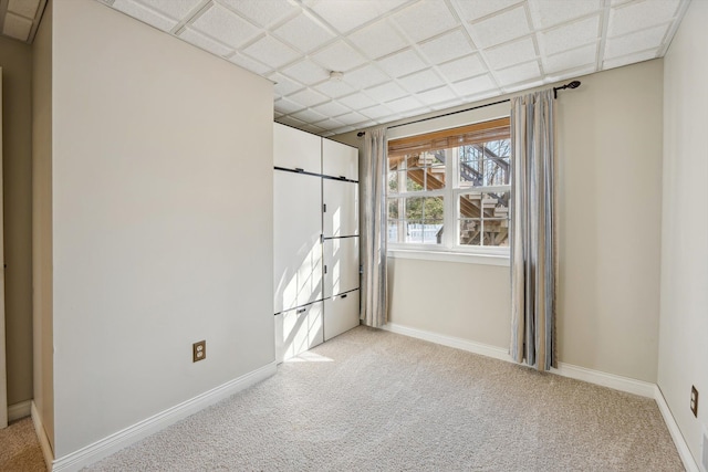 unfurnished bedroom featuring light colored carpet and baseboards