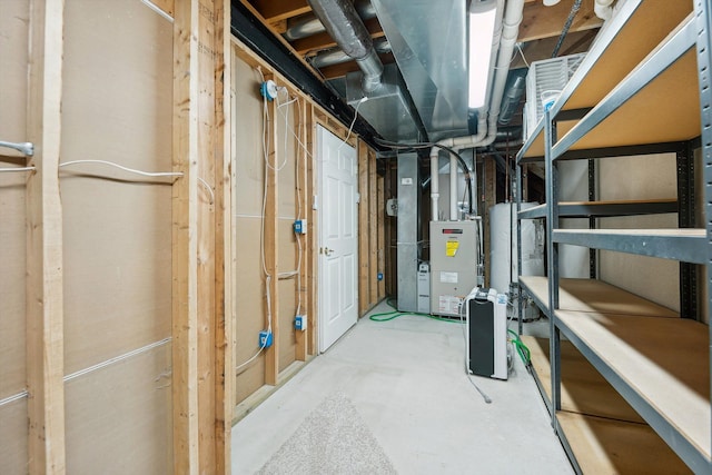 unfinished basement featuring heating unit and water heater