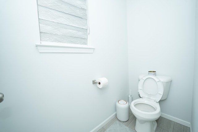 bathroom with toilet and baseboards