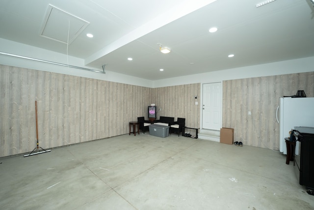 interior space with freestanding refrigerator and recessed lighting