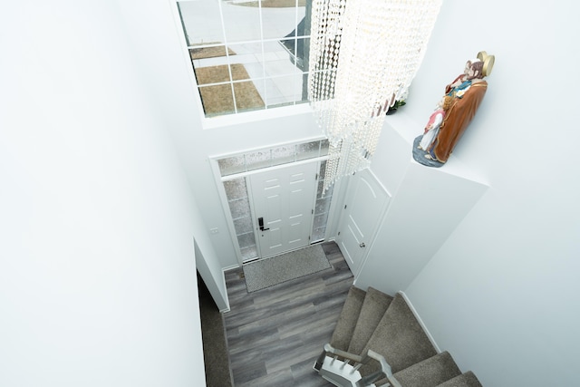 foyer featuring stairs and wood finished floors