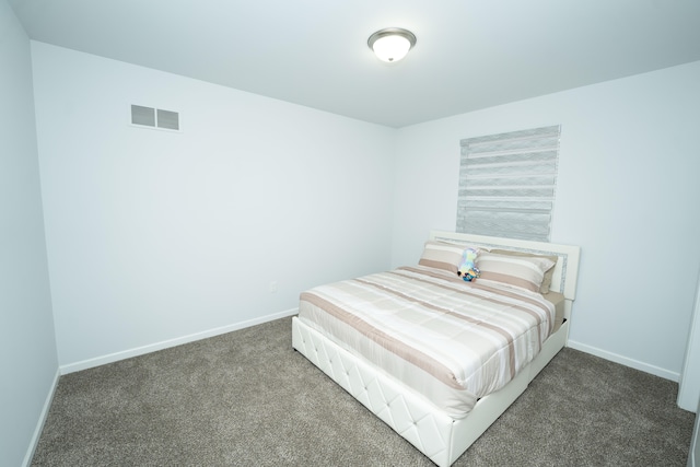 carpeted bedroom with baseboards and visible vents