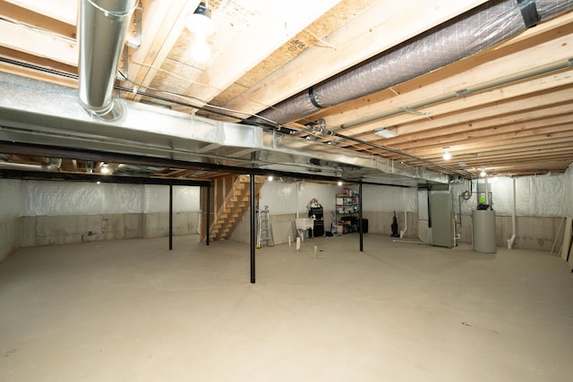 unfinished basement featuring water heater, heating unit, and stairs