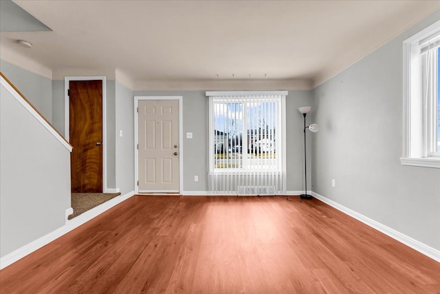 foyer with baseboards and wood finished floors