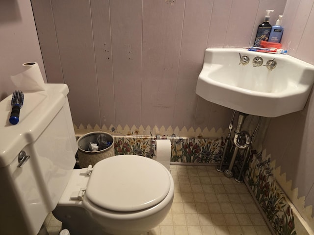 bathroom featuring a sink, toilet, and tile patterned floors