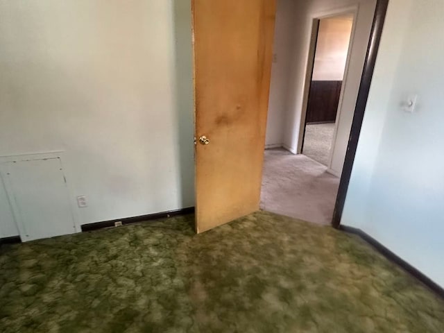 empty room with carpet and baseboards