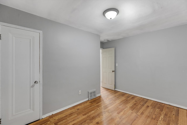 interior space featuring visible vents, baseboards, and wood finished floors