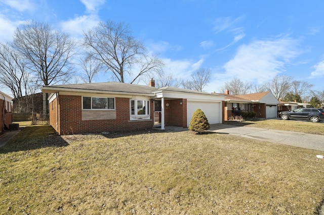 ranch-style home with an attached garage, a chimney, concrete driveway, a front lawn, and brick siding