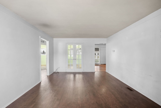 unfurnished living room featuring visible vents, french doors, and hardwood / wood-style floors