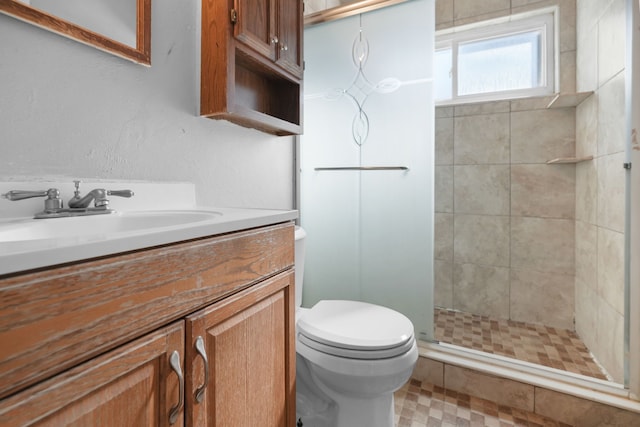 bathroom featuring vanity, toilet, and a shower stall