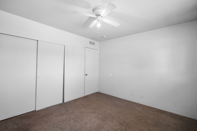 unfurnished bedroom with visible vents, carpet, a closet, and a ceiling fan