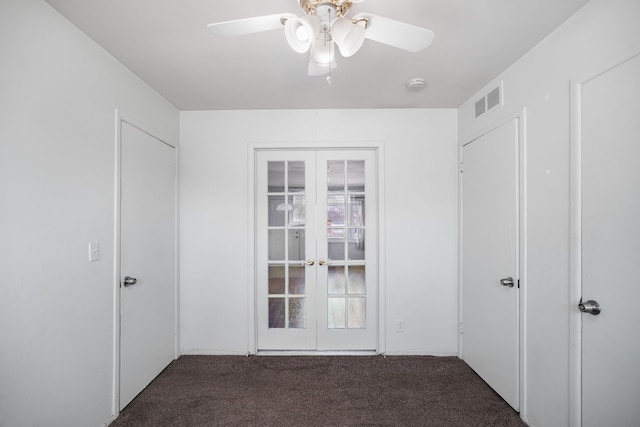 interior space with visible vents, french doors, a ceiling fan, and carpet floors