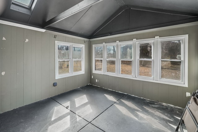 unfurnished sunroom with vaulted ceiling with skylight