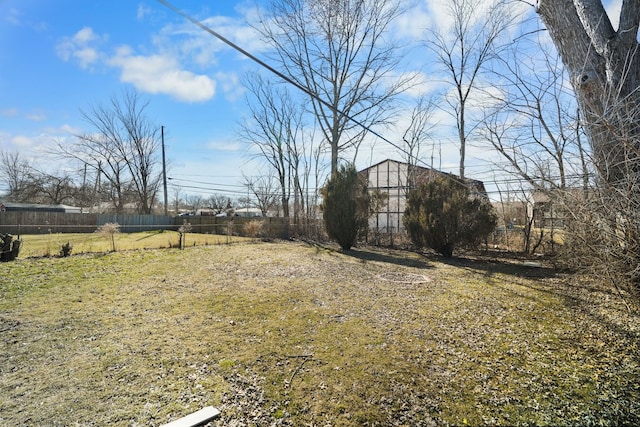 view of yard with an outdoor structure and fence