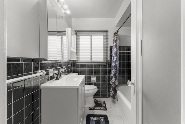 full bathroom with toilet, shower / tub combo, vanity, tile walls, and marble finish floor