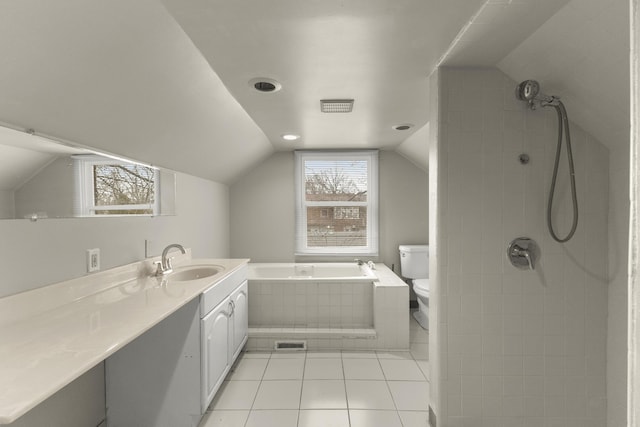 bathroom with a garden tub, lofted ceiling, toilet, vanity, and tiled shower