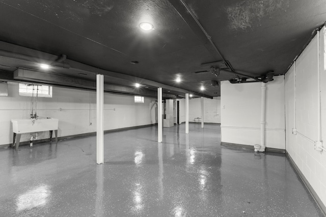 garage with concrete block wall and a sink