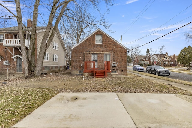 view of front of property with brick siding and fence