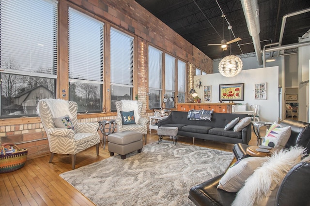 living area with a high ceiling and hardwood / wood-style floors