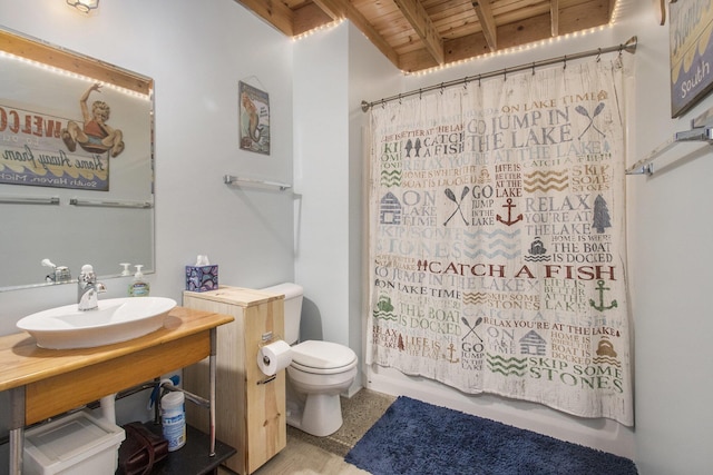 bathroom featuring beam ceiling, shower / tub combo with curtain, toilet, wood ceiling, and a sink