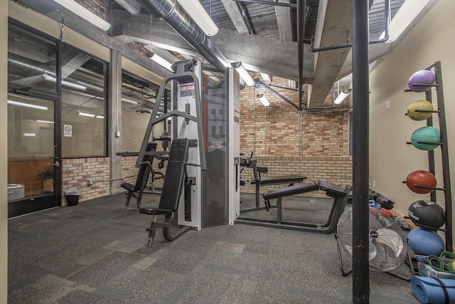 exercise room with brick wall