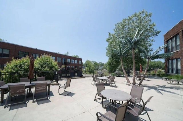 surrounding community with fence and a patio