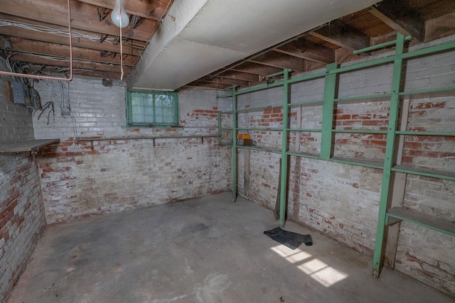 unfinished basement featuring brick wall