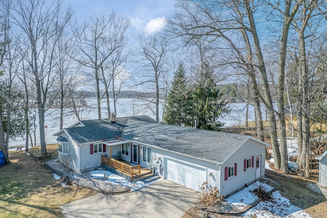 view of front of property with a garage, driveway, a chimney, and a shingled roof